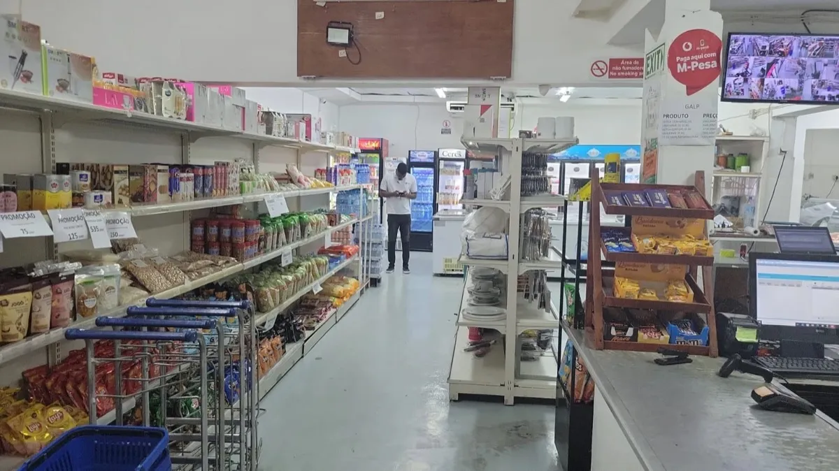Supermarket aisle with groceries, snacks and the M-Pesa sign