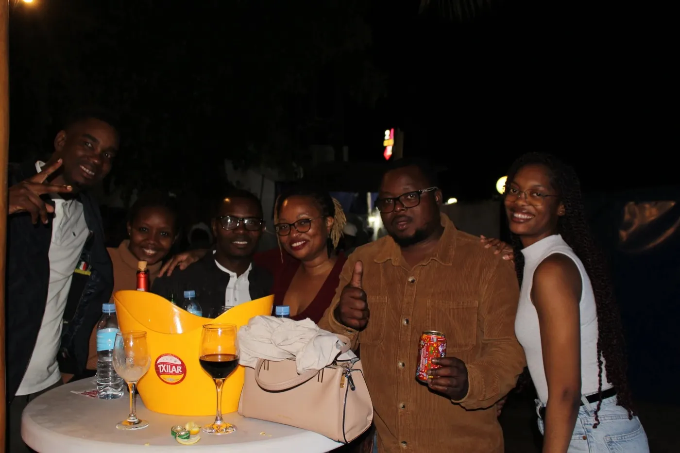 A group of friends around a table with drinks