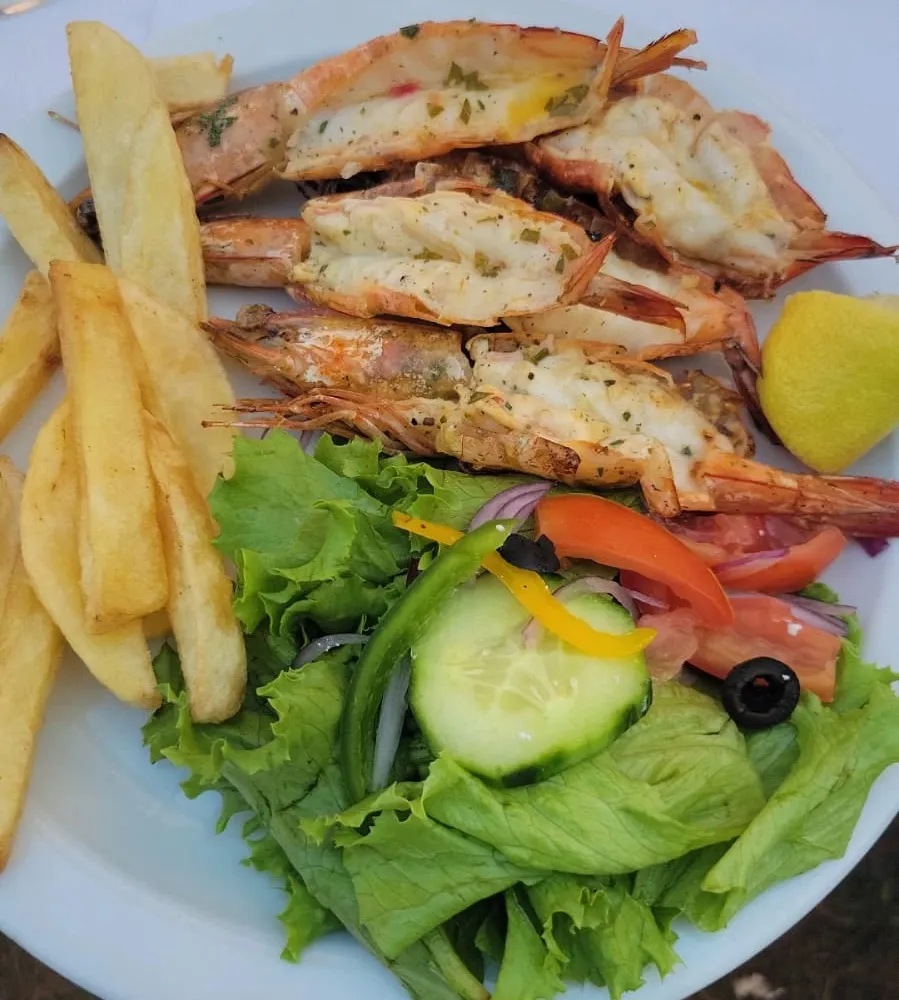 Grilled tiger prawns with chips and salad